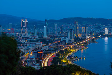 Fototapeta premium View of Izmir Bay in the evening from the high hill of Bayrakli. Long exposure, low light.