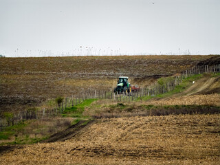 Obraz premium Big drought, very dry land. Autumn on the farm, countryside in fall season, tractor plows ground
