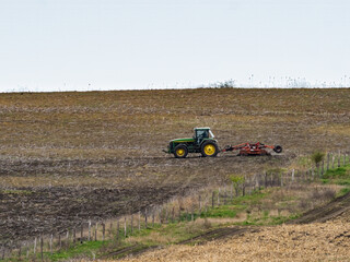 Big drought, very dry land. Autumn on the farm, countryside in fall season, tractor plows ground
