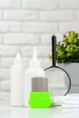 Green Comb on a Countertop with Lice Treatment Products