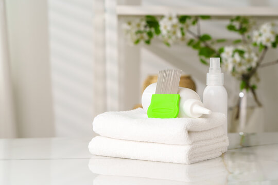 Bottles of Lice Treatment Products and a Comb on a Countertop