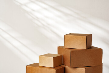Stacked Cardboard Boxes On Wooden Surface In Sunlight