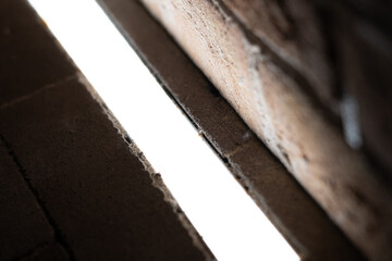 Neon light installed on the ground illuminates the pathway leading to an apartment building
