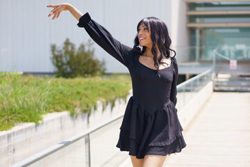 Vital woman raising hand while dancing under the sun