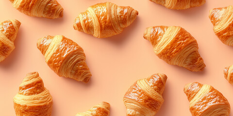 freshly baked croissants arranged in a neat, aesthetically pleasing pattern on a soft pastel background