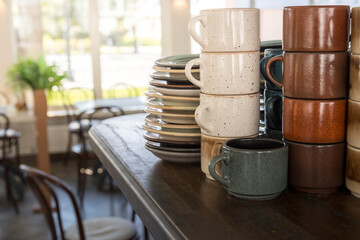 A stack of plates and cups on a table