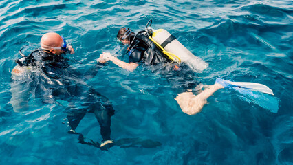 experienced diver instructor teaches a beginner diver to dive in Egypt © Sofiia