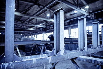 Storage steel metal with structural material on shelves in building warehouse. Industrial distribution background, blue color tone