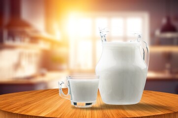 Glass and jug of fresh milk on the desk