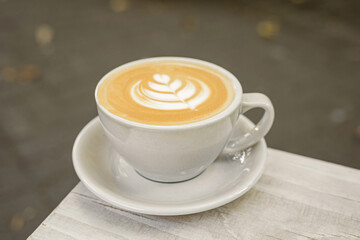 A cup of cappuccino on the table outside