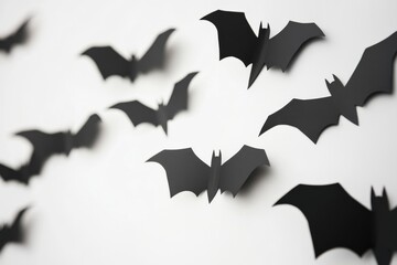 halloween, eerie decor idea - black cut-out bats against a white canvas