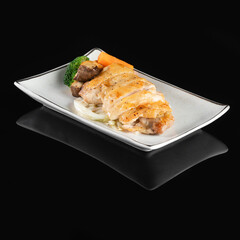 Grilled Sea Bream Dorado fillets served on fresh salad. Black background. Top view.
