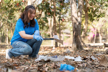 Volunteer Using Litter Picker in Woodland Clean Up