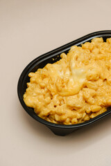 Mac and cheese tasty Italian pasta with Cheddar cheese on plain background