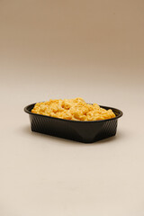 Mac and cheese tasty Italian pasta with Cheddar cheese on plain background