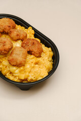 Mac and cheese tasty Italian pasta with Cheddar cheese on plain background