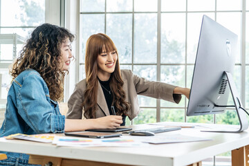 Collaboration of graphic design business people with computer in an office company. Two corporate women in creative marketing team working on project management, Designer teamwork, web design
