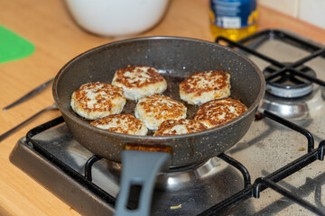 Meat burgers or cutlet-shaped patty being shallow fried in oil on a frying pan, close up. version of cutlets - kotlety.