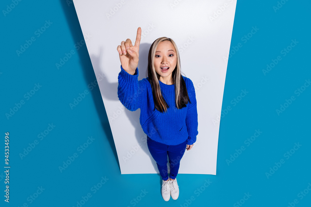 Wall mural photo of chinese girl near digital mobile phone display point finger up genius plan advertisement is