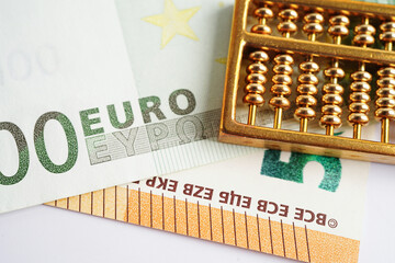 Gold abacus on banknote money, finance trading investment business currency concept.