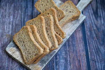 Hard rusk chuck crackers,basil  and parmesan chesese  on wooden table.Italian snack