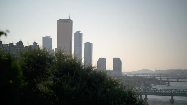 Scenic View of Yeouido Skyline and 63 Building Overlooking the Han River and Bridges: Cinematic Afternoon Landscape from Yongyangbong Jeojeong Park