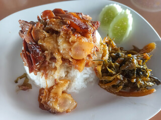 Rice with Pork Leg Stew on white plate.