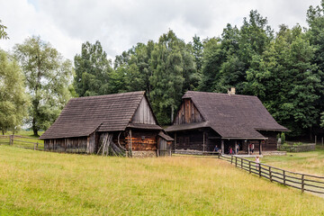 ROZNOV POD RADHOSTEM, CZECH REPUBLIC - JULY 15, 2021: Wooden houses in the open air museum (Valasske muzeum v prirode) in Roznov pod Radhostem, Czechia