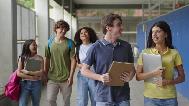 Group of cheerful secondary school students going back to classes. Teenager friends arriving walking to High School College. Diversity in Education