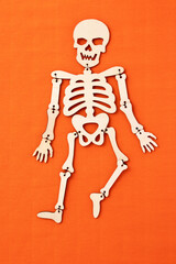 Halloween skeleton on orange background