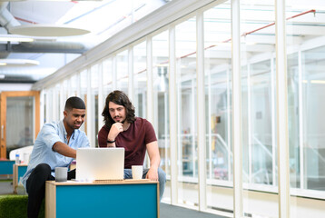 Pointing, business people and laptop with team in office, planning and online research for startup....