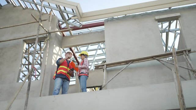 Blue collar workers are building house. Construction and blue collar worker.
