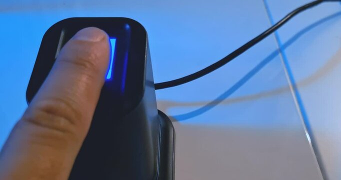 user uses fingerprint reader to access a security system near a notebook pc, concept of security