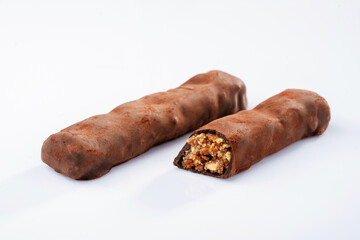 Chocolate bars lie on a white surface, isolated