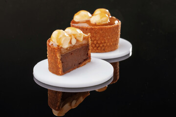 Front view, close up. Delicious cake against black background