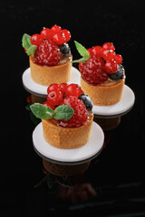 Fruits, fresh mix. Desserts, sweets on the black background