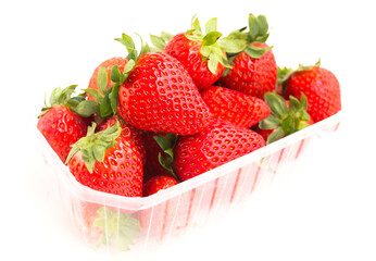 Fresh appetizing strawberries in a plastic tray onwhite background