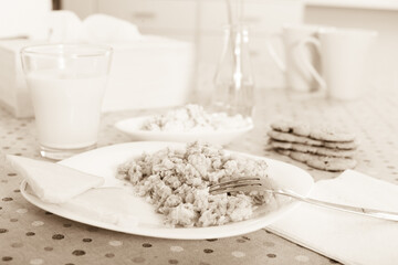 Breakfast of oatmeal, biscuits and milk