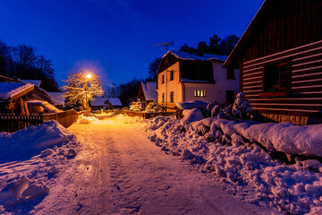 Evening winter view of snow covered Hruba Skala village, Czech Republic