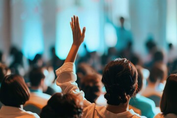 Back view of a woman raising her arm on a seminar. Rear view of casual businesswoman raising her arm to ask the question on education event in a board room.