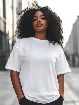 African american young woman plus size model in cotton plain white t-shirt on city street background. Big size clothing mock up for print or branding