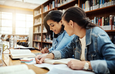 Women, university student and group work at library with textbook for research, teamwork and...
