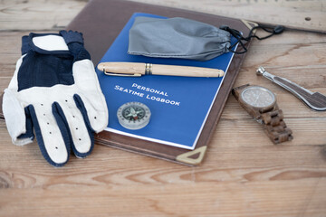 blue Personal Seatime Logbook, Sailing Leather Gloves without fingertips for marine enthusiasts. Seafarer documentation, compass, yacht captain accessories, adventure at sea