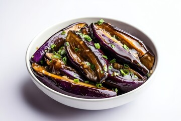 Fototapeta premium A bowl of cooked eggplant garnished with green onions.