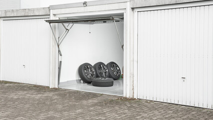 Private garage background. Car tire set in private garage.