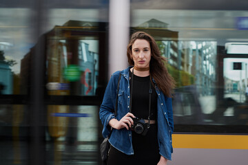 Photographer, portrait and woman travel by train with camera in city for memory, vacation or tourism. Photography, subway or girl in urban street for public transportation with journalist in New York