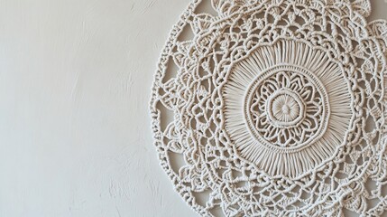 Detailed macrame art with a mandala pattern, displayed on a neutral-toned wall