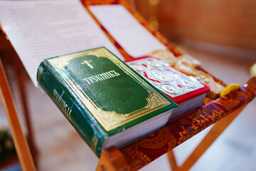 A prayer book with an inscription in Old Russian on the table for the priest at a church service....