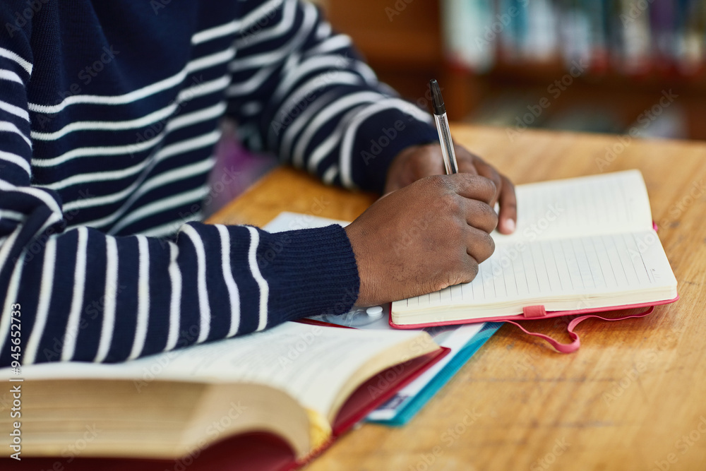 Poster education, notebook and writing with hand of student in library of university for learning or study.