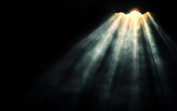 A stunning display of light beams emerging from darkness, creating a dramatic and ethereal atmosphere.